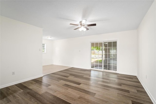 unfurnished room with ceiling fan, plenty of natural light, and dark hardwood / wood-style flooring