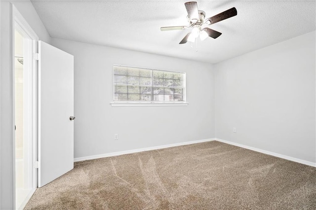 spare room featuring ceiling fan, a textured ceiling, and carpet flooring