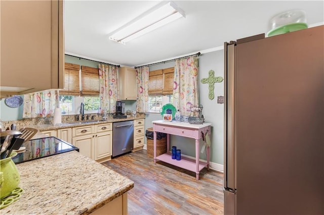 kitchen with dishwasher, light hardwood / wood-style floors, sink, light stone counters, and fridge