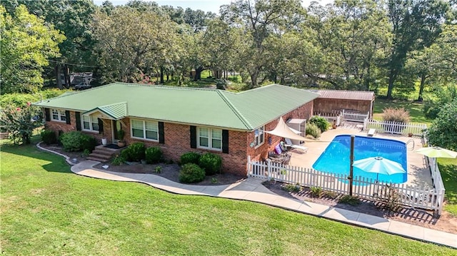 view of pool featuring a lawn