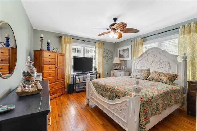 bedroom with ceiling fan and wood-type flooring