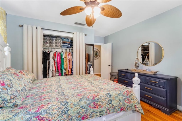 bedroom with ceiling fan, light hardwood / wood-style flooring, and a closet