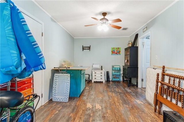 bedroom featuring ceiling fan, ornamental molding, and wood-type flooring