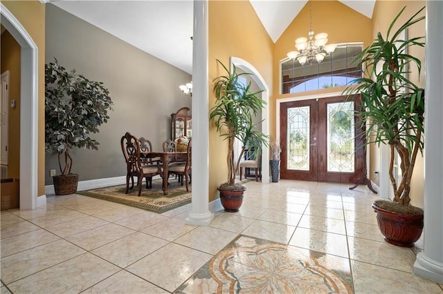 2765 Knollwood Dr, Mobile, AL 36693 - foyer featuring a chandelier, high vaulted ceiling, arched walkways, tile patterned floors, and baseboards