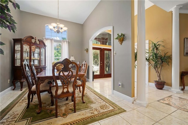 2765 Knollwood Dr, Mobile, AL 36693 - dining space with french doors, light tile patterned floors, ornate columns, high vaulted ceiling, and a chandelier