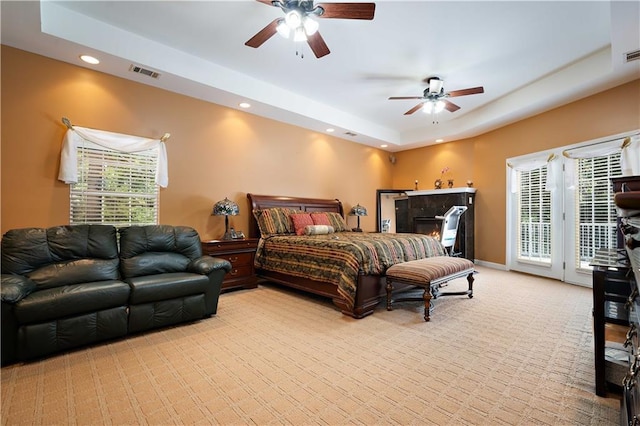 2765 Knollwood Dr, Mobile, AL 36693 - carpeted bedroom featuring access to outside, a tray ceiling, recessed lighting, a tiled fireplace, and a ceiling fan