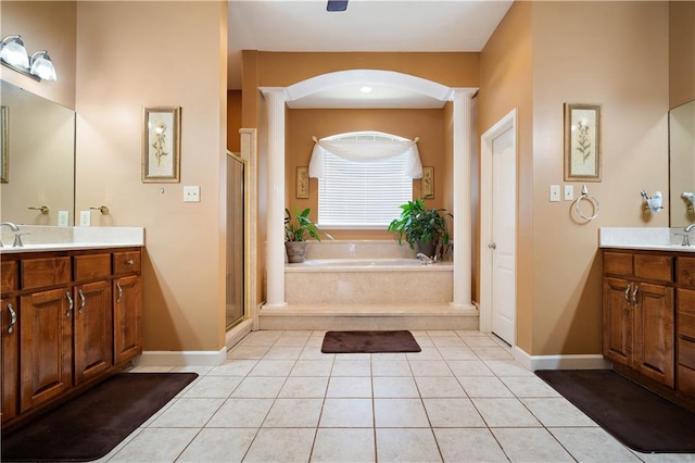 2765 Knollwood Dr, Mobile, AL 36693 - bathroom with a shower stall, a bath, two vanities, tile patterned flooring, and baseboards