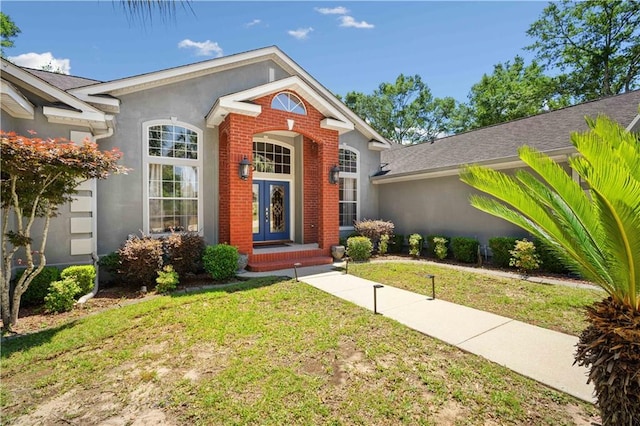 2765 Knollwood Dr, Mobile, AL 36693 - view of front of house featuring a front yard, brick siding, and stucco siding