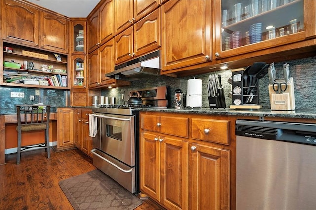 2765 Knollwood Dr, Mobile, AL 36693 - kitchen with stainless steel appliances, under cabinet range hood, brown cabinets, and tasteful backsplash