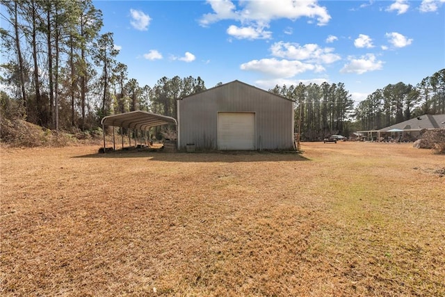 view of yard with a garage, an outdoor structure, and a carport