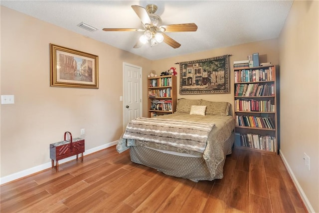 bedroom featuring hardwood / wood-style flooring and ceiling fan