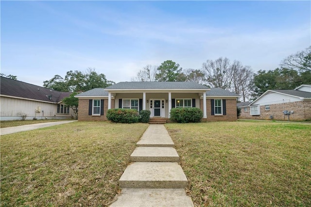 view of front of house featuring covered porch, a front lawn, and brick siding