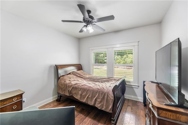bedroom with a ceiling fan, dark wood-style flooring, and baseboards