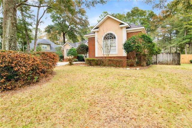 view of side of property with a yard