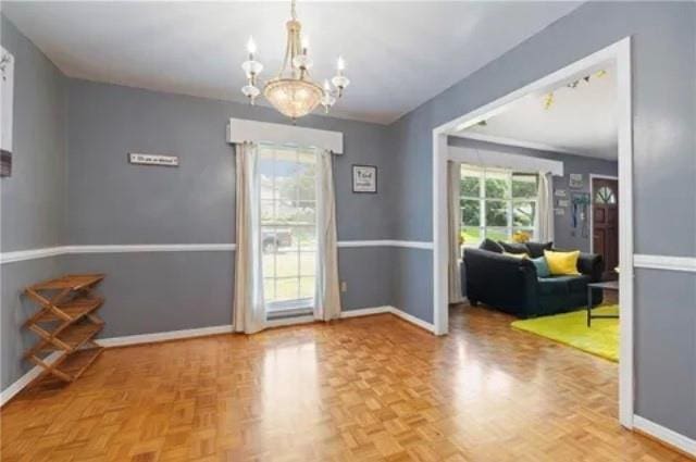 doorway to outside with an inviting chandelier and parquet floors