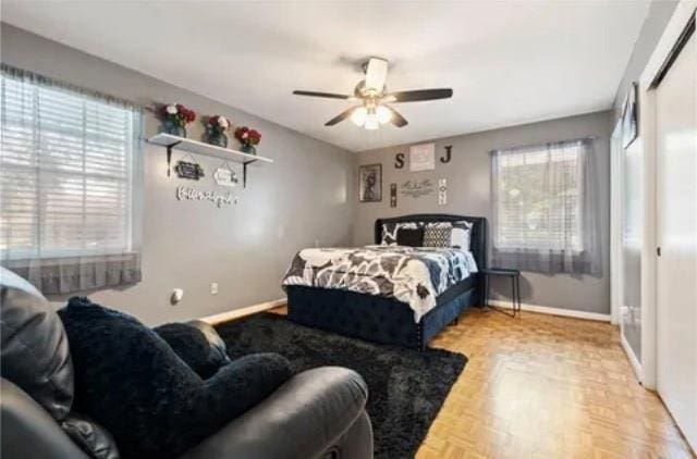 bedroom with ceiling fan and parquet flooring