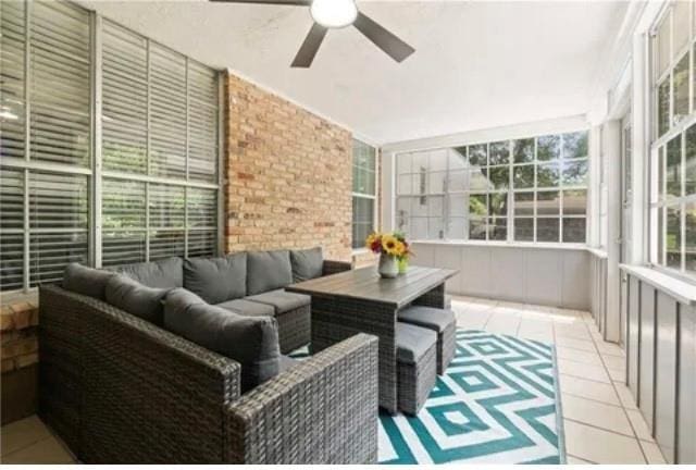 sunroom featuring ceiling fan