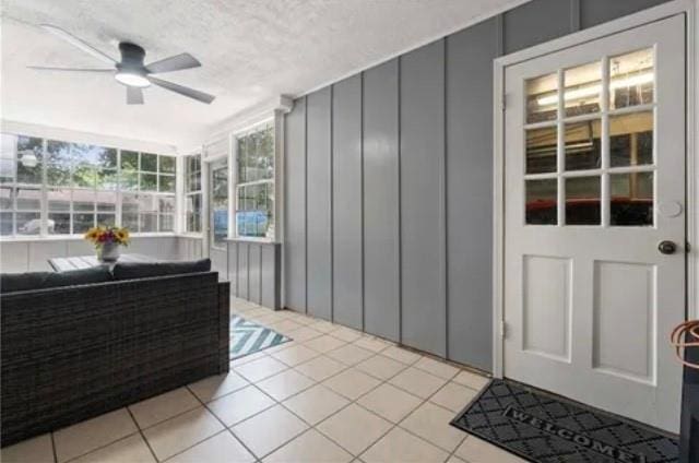 sunroom featuring ceiling fan