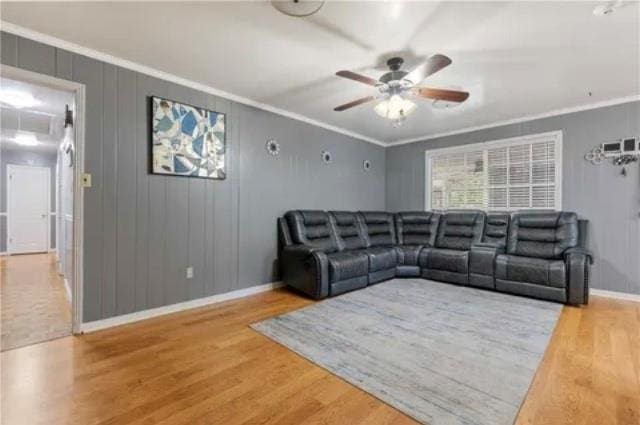 living room with ceiling fan, hardwood / wood-style floors, and ornamental molding