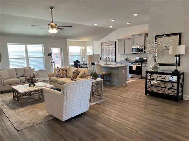 living room with ceiling fan, lofted ceiling, sink, and dark hardwood / wood-style flooring