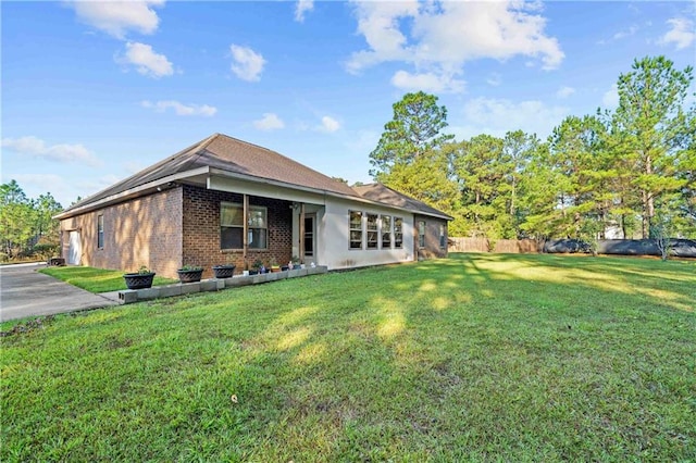 back of property featuring a lawn