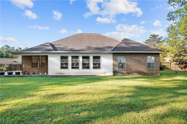 back of house featuring a lawn