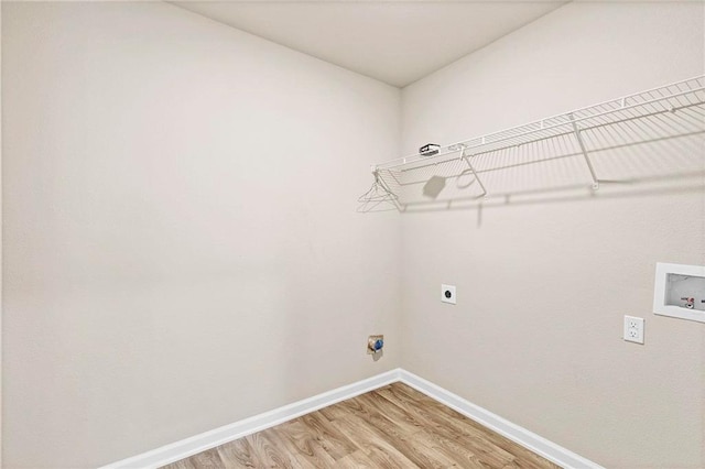 washroom featuring baseboards, washer hookup, laundry area, hookup for an electric dryer, and light wood finished floors