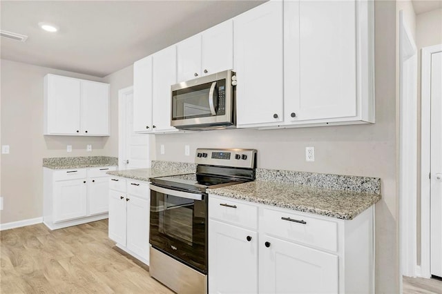 kitchen featuring light stone countertops, visible vents, stainless steel appliances, light wood finished floors, and baseboards