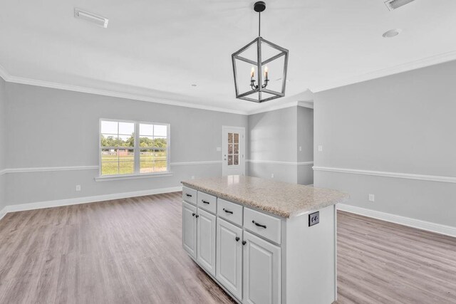 21621 Coleman Cemetery Rd, Moss Point, MS 39562 - kitchen featuring open floor plan, light wood-style floors, a kitchen island, a chandelier, and ornamental molding