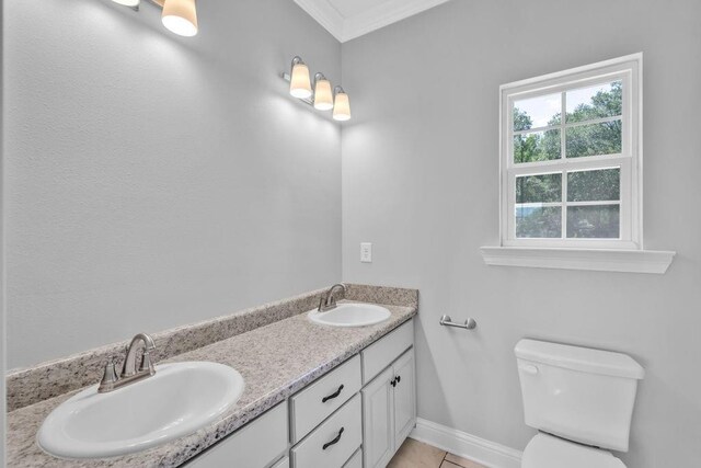 21621 Coleman Cemetery Rd, Moss Point, MS 39562 - bathroom featuring toilet, double vanity, crown molding, and baseboards