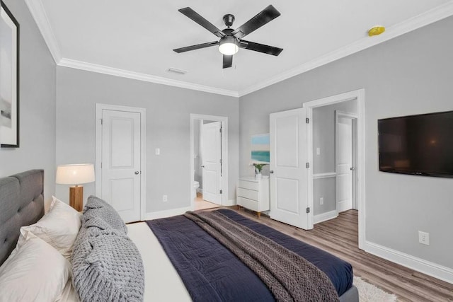 21621 Coleman Cemetery Rd, Moss Point, MS 39562 - bedroom with ornamental molding, wood finished floors, baseboards, a ceiling fan, and ensuite bathroom