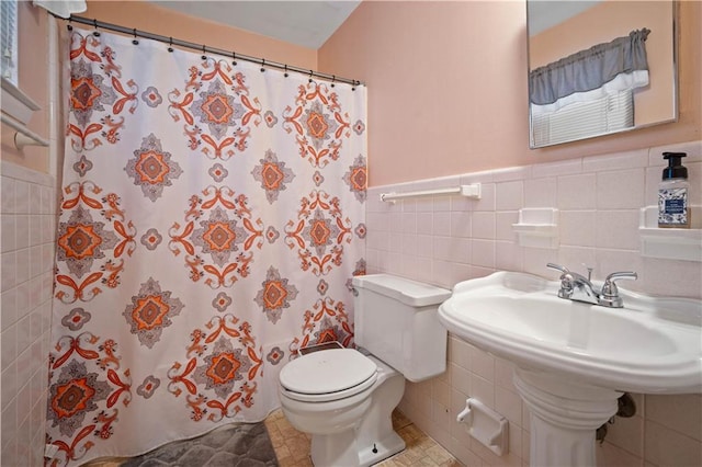 513 Samauri Ct, Saraland, AL 36571 - full bathroom with tile walls, toilet, a shower with shower curtain, a wainscoted wall, and a sink