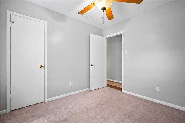 unfurnished bedroom featuring ceiling fan and light carpet