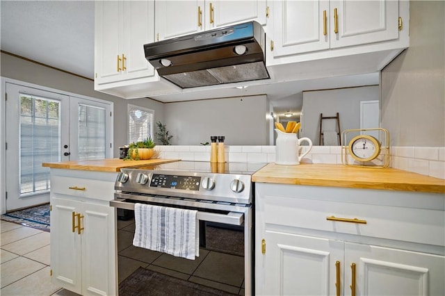 kitchen featuring white cabinetry, stainless steel electric stove, extractor fan, and wooden counters