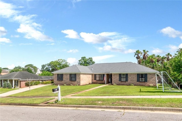 7250 Pine Station Rd S, Mobile, AL 36695 - ranch-style home with driveway, a front lawn, and brick siding