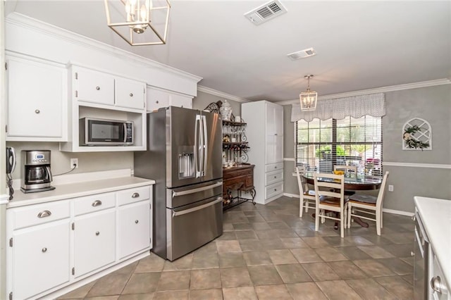 7250 Pine Station Rd S, Mobile, AL 36695 - kitchen with appliances with stainless steel finishes, ornamental molding, light countertops, white cabinetry, and a chandelier