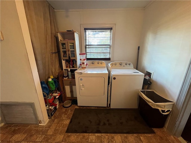 clothes washing area with washer and clothes dryer