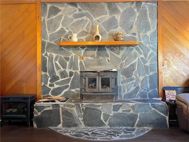 interior details featuring a wood stove and wood walls