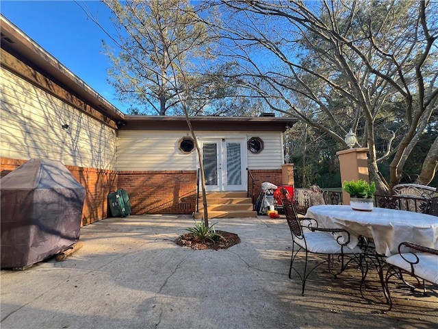 view of patio / terrace featuring a grill and french doors