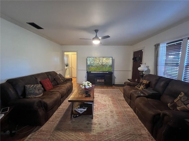 living room featuring hardwood / wood-style floors and ceiling fan