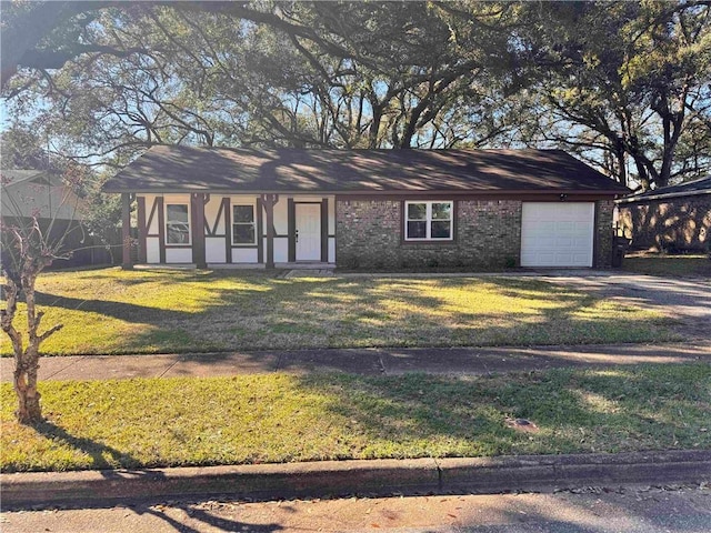 view of front facade featuring a garage, a front yard, brick siding, and driveway