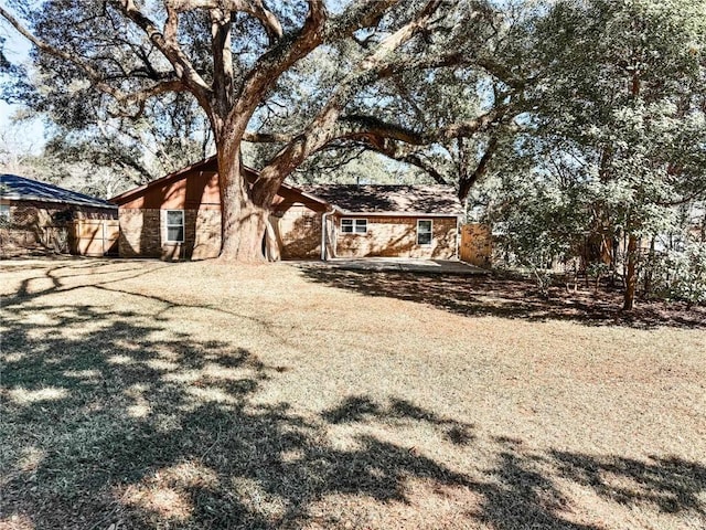 view of front of house with stone siding and fence