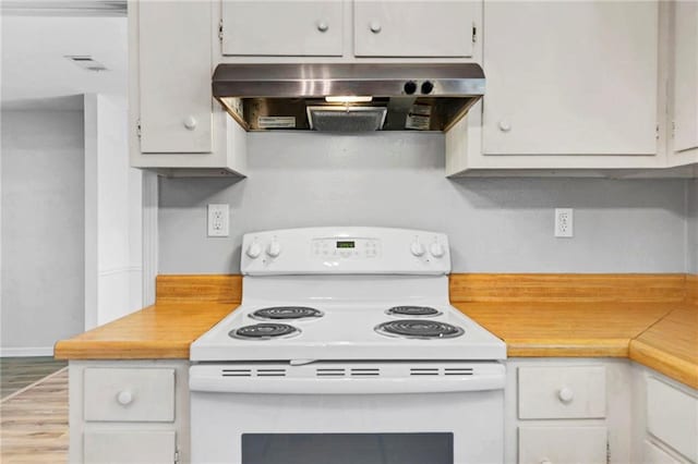 kitchen with under cabinet range hood, visible vents, white cabinetry, light countertops, and white electric range oven