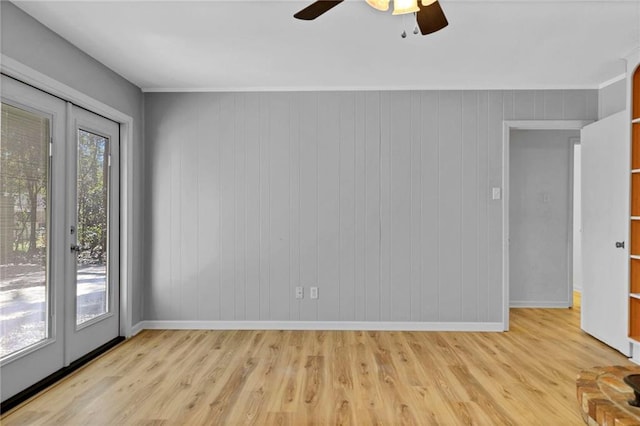 unfurnished room with a ceiling fan, a healthy amount of sunlight, light wood-style flooring, and baseboards