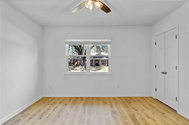 unfurnished bedroom with baseboards, ceiling fan, and light wood-style floors