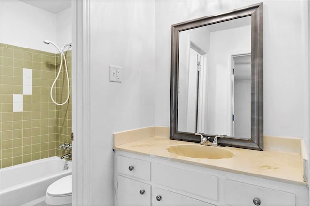 bathroom with toilet, vanity, and bathing tub / shower combination