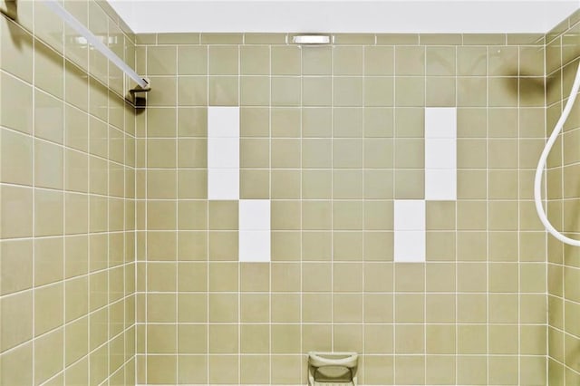 full bath with a tile shower