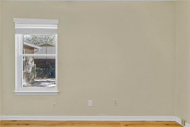 unfurnished room featuring wood finished floors and baseboards