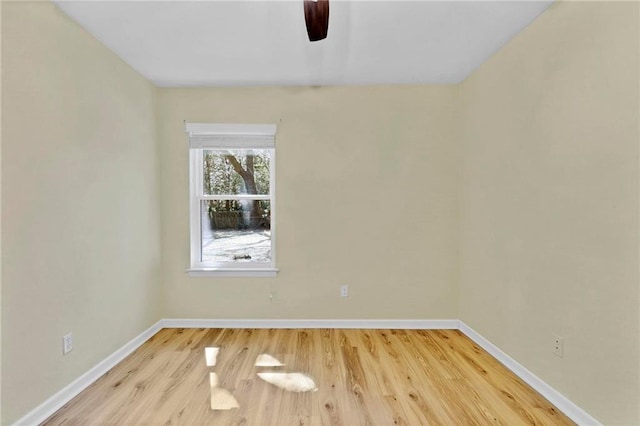 unfurnished room featuring wood finished floors, a ceiling fan, and baseboards