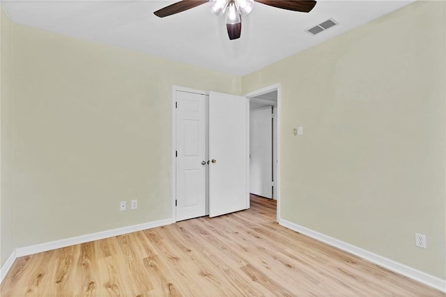 unfurnished bedroom with a ceiling fan, baseboards, visible vents, and light wood finished floors